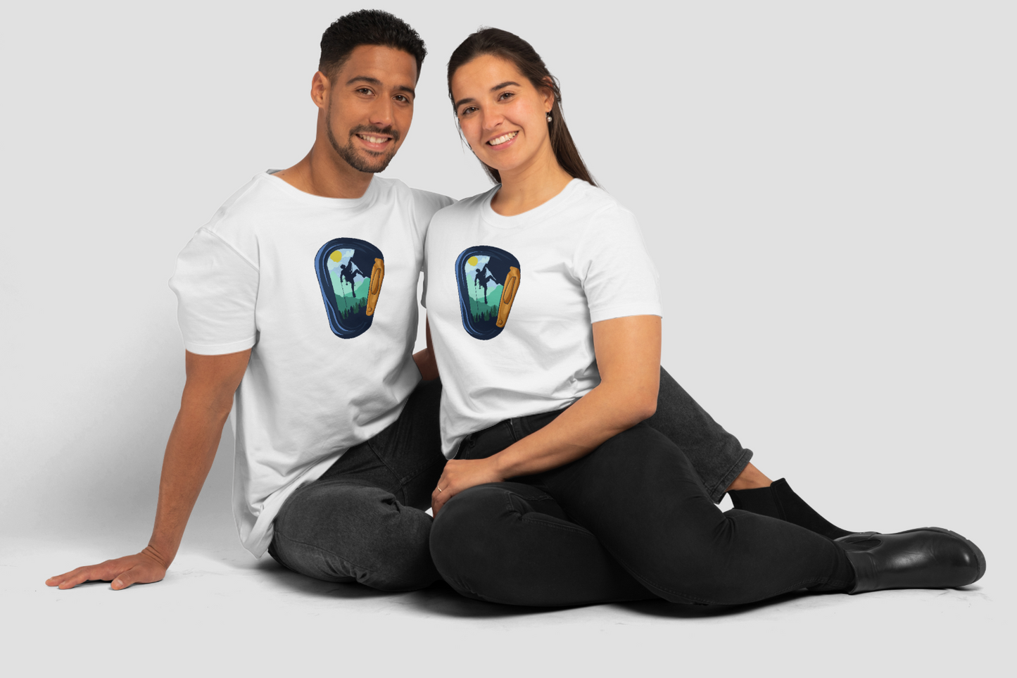 Happy Hispanic couple wearing Knot Qualified women's softstyle carabiner climbing t-shirt in a mockup setting.